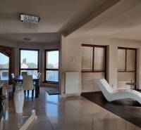 Living room with dining area and lounger in a family house.
