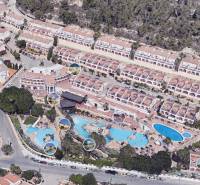 A holiday apartment in Calpe surrounded by villas and swimming pools with panoramic views.