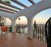 A balcony with a view of the rooftops and the sea in a holiday apartment in Calpe.