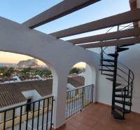 Balcony of a holiday apartment in Calpe with a sea view and a spiral staircase.