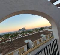 View from a holiday apartment in Calpe of the sea and rooftops during sunset.