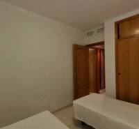 Two single beds and a wooden wardrobe in the Holiday Apartment.