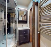 A bathroom in a 3-room apartment with a hydromassage shower and a sink.