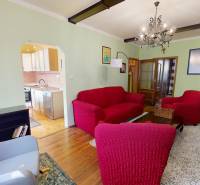 A living room with a fireplace and red sofas in a three-room apartment.
