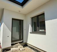 Entrance to a family house in Mostová with stylish windows and a white facade.