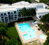 In Piešťany on Rekreačná, there is a complex with a pool surrounded by greenery and modern architecture.