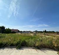 Lands - housing in Slovenská Nová Ves with a view of houses and a vehicle.
