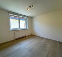 A bright room with a window and wooden floor in a 3-room apartment.