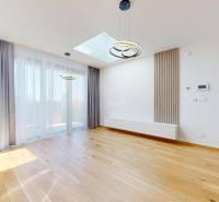 Bright living room with wooden flooring and curtains in a two-room apartment.