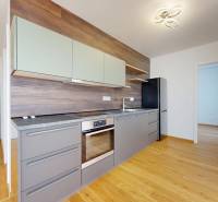 Kitchen in a 2-room apartment, wooden floor, built-in appliances.