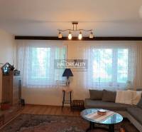 Living room in a 3-room apartment with a sofa, table, and shelf.