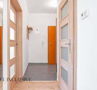 Entrance hallway in a 2-room apartment with wooden doors and tiles.