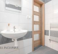 Bathroom in a 2-room apartment with a sink, mirror, and heating ladder.
