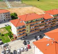 Aerial view of residential buildings on Záhradnícka Street, Dunajská Streda, with a parking lot and land.