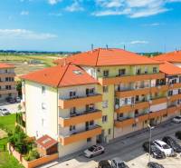 Apartment buildings on Záhradnícka Street in Dunajská Streda with a parking lot and surroundings.
