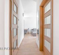Hallway in a 2-room apartment with wooden doors and a mirror.