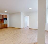 A kitchen unit in a 2-room apartment with wooden flooring and white walls.