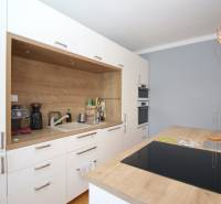 Kitchen in a 2-room apartment with a wooden countertop and a stove.