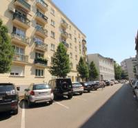 A view of apartment buildings and parked cars on Medená Street in Bratislava.