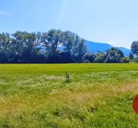 Vast meadows near Podtureň, ideal for residential plots, surrounded by mountains and forests.