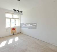 A room in a family house with a large window and lighting.