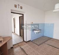 An interior with a sink, blue tiles, and open doors in a family house.