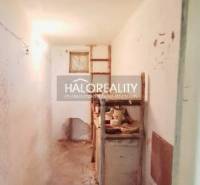 A narrow corridor with an old kitchen unit in a family house.