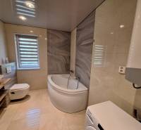 Bathroom in a 4-room apartment with a shower and a washing machine.