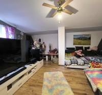 Living room in a family house with a large television and a comfortable sofa.