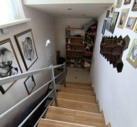 A staircase in a family house with wall decoration and a photo gallery.