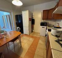 A kitchen in a family house with wooden furniture and appliances.