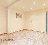 Interior of a family house with an empty room, a picture on the wall, and ceiling lighting.