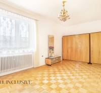 Bright room with wooden floor, wardrobes, and a mirror in a family house.