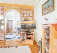 Living room in a family house with a television, a wardrobe, and a houseplant.