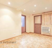 Interior of a room in a family house with doors, laminate flooring, and curtains.