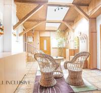 Rustic interior of a family house with wicker furniture and wooden elements.