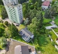 View of the apartment building and greenery on Slnečná Street in Kováčová, Residential plots.
