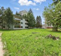 Greenery and buildings on Slnečná Street in Kováčová, suitable for residential land.
