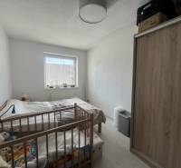 A bright room in a 2-room apartment with a baby crib and a wardrobe.