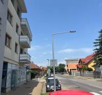 Štúrova Street in Senec with commercial spaces and parked cars.