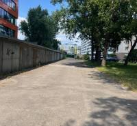 Garages on Budovateľská Street in Bratislava - Ružinov, shown alongside greenery and trees.