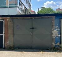 Garages on Budovateľská Street in Bratislava-Ružinov, in the middle of a clear summer day.