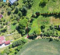 Aerial view of a residential plot in the village of Visolaje surrounded by greenery and houses.