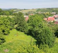 Greenery surrounds residential plots in Visolaje, with visible surrounding houses and landscape.