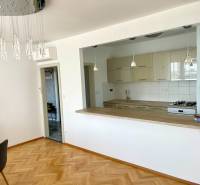 Open-plan kitchen with dining area in a 2-room apartment.