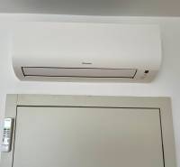 Air conditioning with a remote control on the wall of a 2-room apartment.