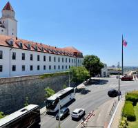Bratislava Castle with buses and cars on the road in Bratislava - Old Town.