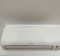 White Daikin air conditioner installed on a white wall in a 2-room apartment.