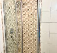 Shower corner with ceramic tiles in a 2-room apartment.
