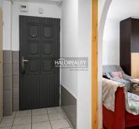 Entrance with tiles and a view into the living room in a 2-room apartment.